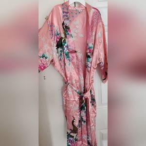 Silk like robe with flowers and peacock details. Size Small. Coral pink color.